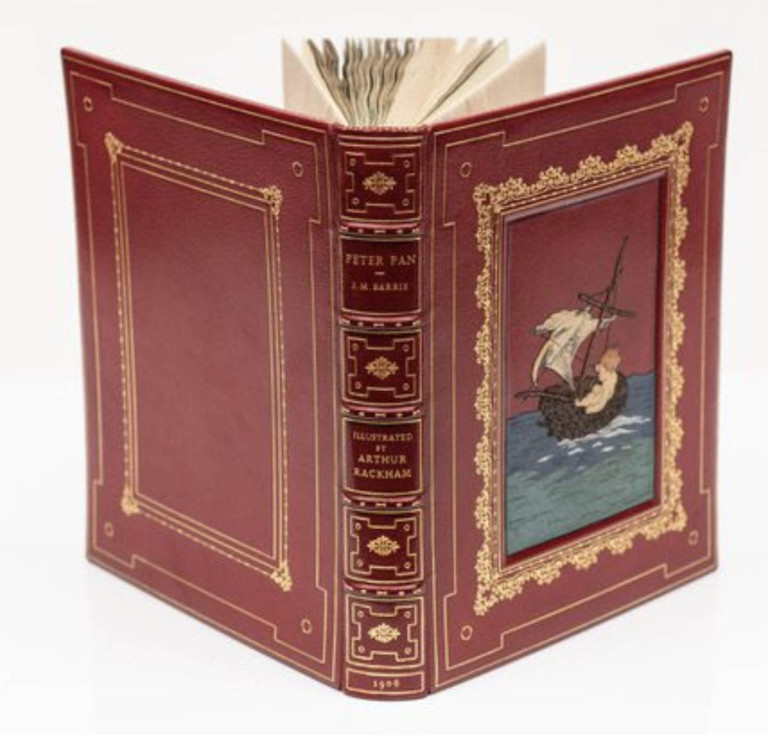 J. M. Barrie's Peter Pan ,bound in full red Morocco with a multi-colored onlay on front cover by Sangorski & Sutcliffe. Illustrated and signed by Arthur Rackham. Offered by Imperial Fine Books.